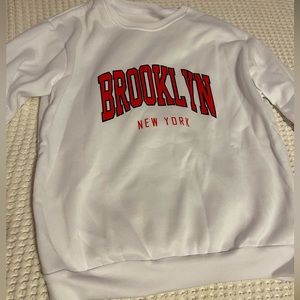 White sweatshirt with red letters